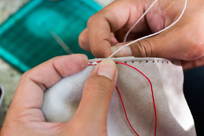 Close-up of hands sewing fabric