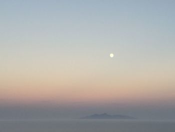 Scenic view of moon against clear sky at sunset