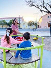 Side view of mother and daughter in park