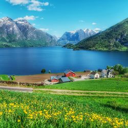 Scenic view of sea and mountains against sky