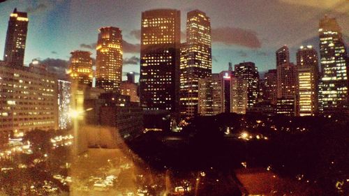 View of skyscrapers lit up at night