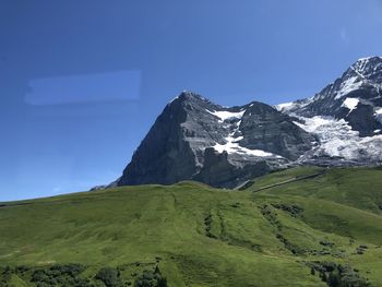 Scenic view of mountains against clear blue sky