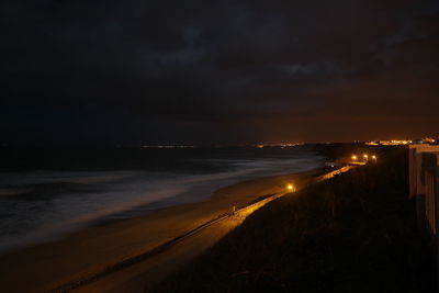 Scenic view of beach against sky at night