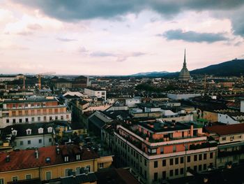 Cityscape against cloudy sky