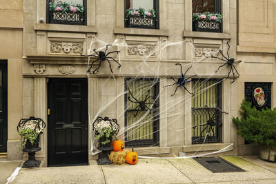 Front of apartment building decorated with spider web for halloween holiday in manhattan new york