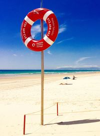 Scenic view of beach against blue sky