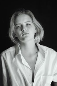 Portrait of a beautiful young woman over black background