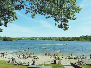 People enjoying in water against sky