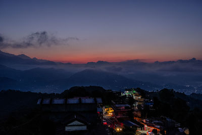 High angle view of illuminated buildings against sky at sunset