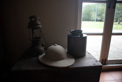 Close-up of electric lamp on window sill at home