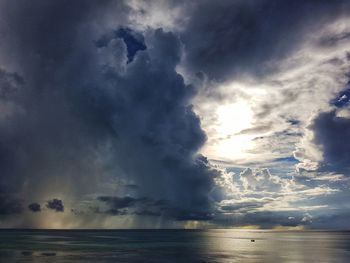 Sunlight streaming through clouds over sea