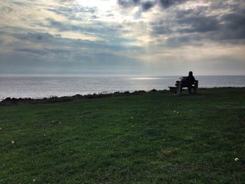 Rear view of man sitting on beach