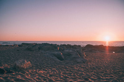 Scenic view of sea against clear sky during sunset