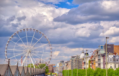 Ferris wheel in city against sky