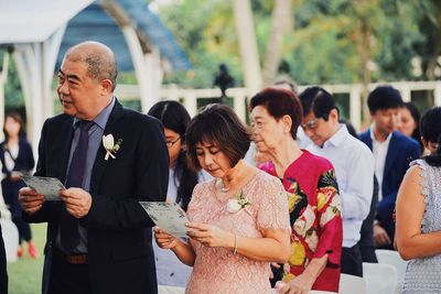 Group of people standing in front of an animal