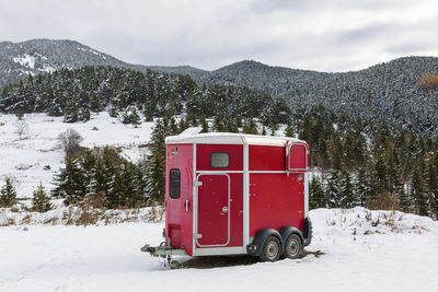Red horse trailer in the mountain