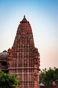 Ancient hindu temple architecture with bright sky from unique angle at day