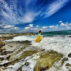 Man surfing in sea against sky