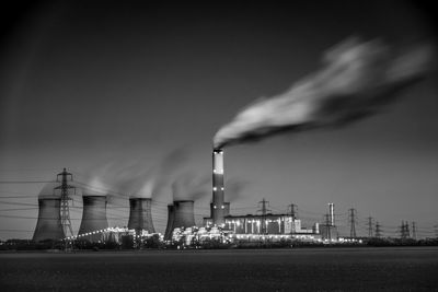 Smoke emitting from factory against sky at night