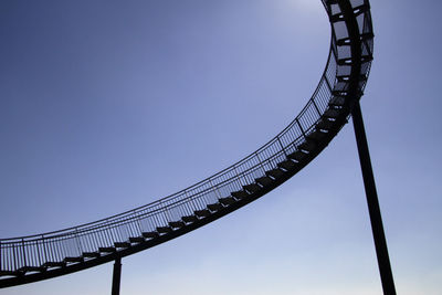 Low angle view of rollercoaster against clear sky