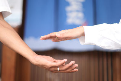 Cropped hand of doctor holding hands