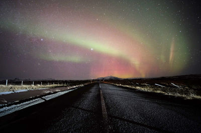 Road against sky at night