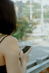 Midsection of woman using mobile phone