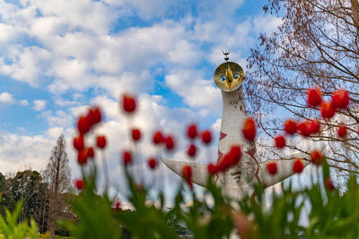 Low angle view of decoration hanging on tree against sky