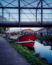 Bridge over river against buildings in city