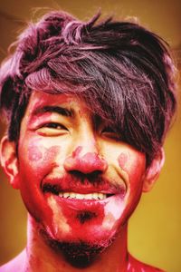 Close-up portrait of young man with powder face paint during holi