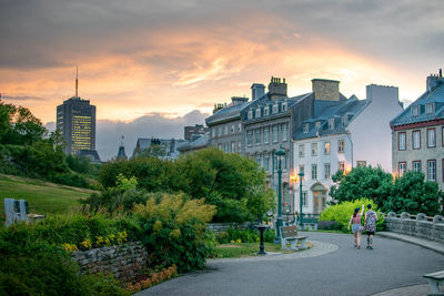 City by buildings against sky during sunset