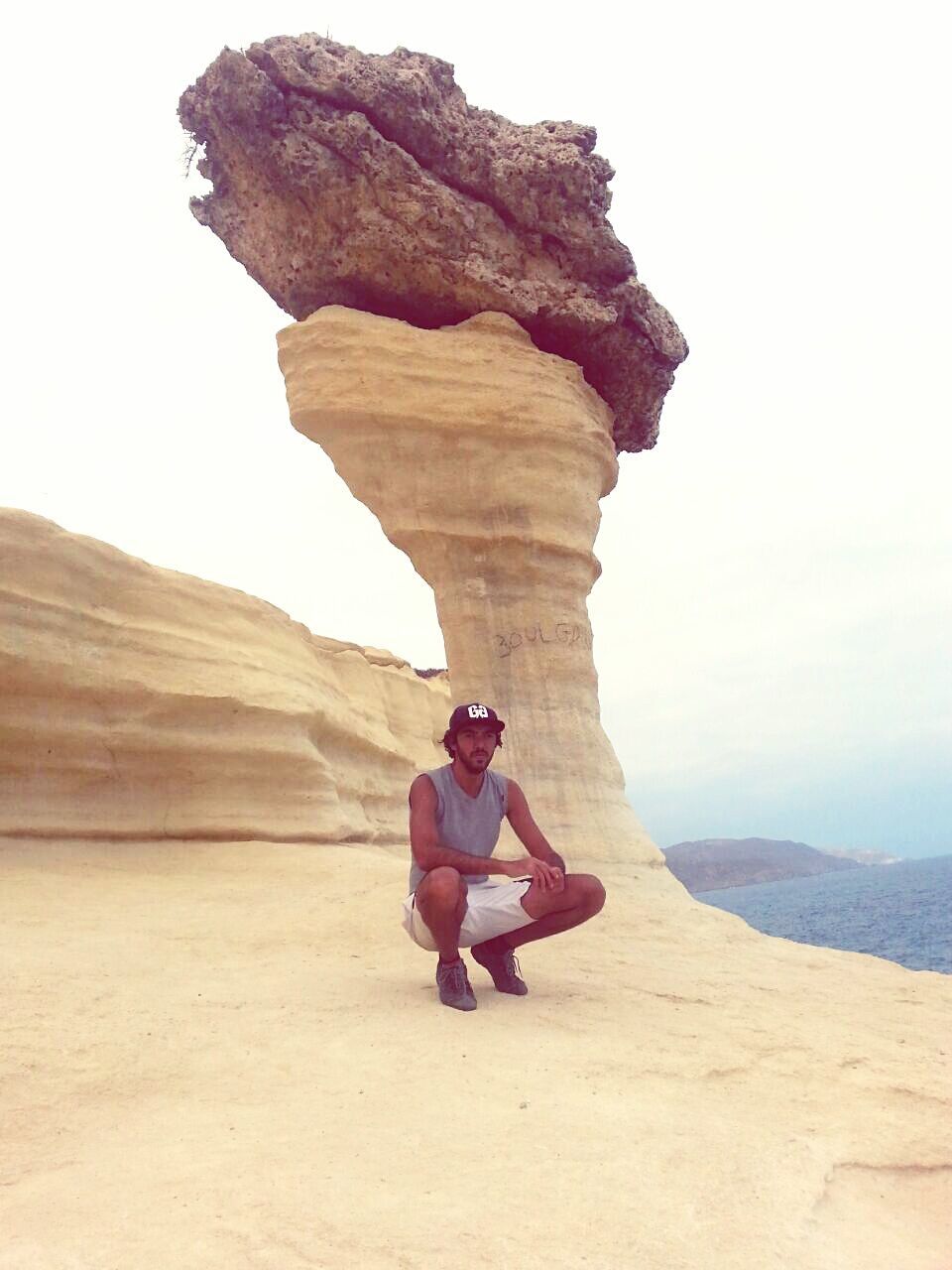 WOMAN CLIMBING ROCK FORMATION