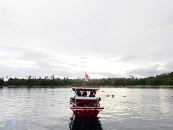 Boat in lake against sky