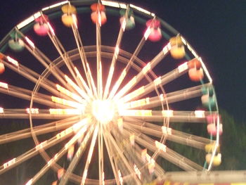 Low angle view of illuminated ferris wheel