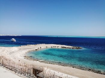 Scenic view of sea against clear blue sky