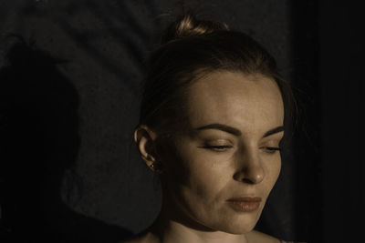 Portrait of a young girl with clean skin on a black background close-up. fresh daily makeup