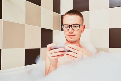 Portrait of young man in bathroom