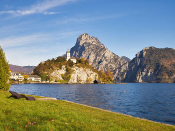 Scenic view of sea and mountains against sky