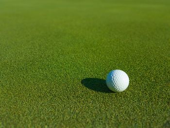 Close-up of golf ball on field