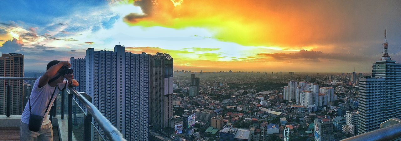 architecture, city, building exterior, built structure, sky, cityscape, sunset, cloud - sky, skyscraper, city life, panoramic, cloud, travel destinations, tall - high, water, tower, modern, railing, cloudy