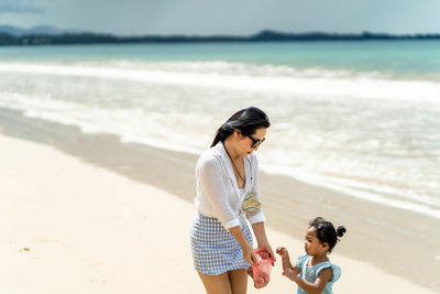 Rear view of woman walking on beach