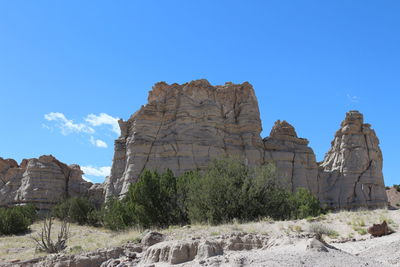 Rock formations against clear blue sky