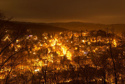 High angle view of illuminated cityscape against sky at night