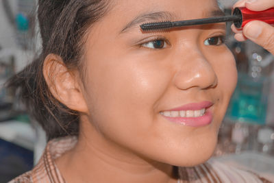 Close-up portrait of a smiling young woman