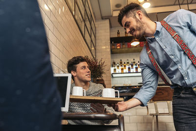 Man serving coffee for customers