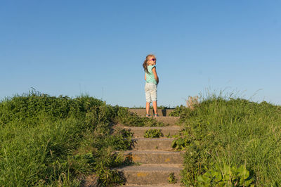 Low angle view of girl standing on steps