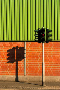 View of sign on wall. traffic light on a green and red background
