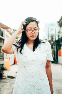 Woman looking away while standing outdoors