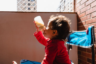 Boy holding bottle 