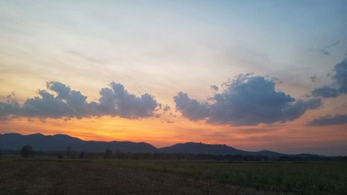 Scenic view of field against sky during sunset